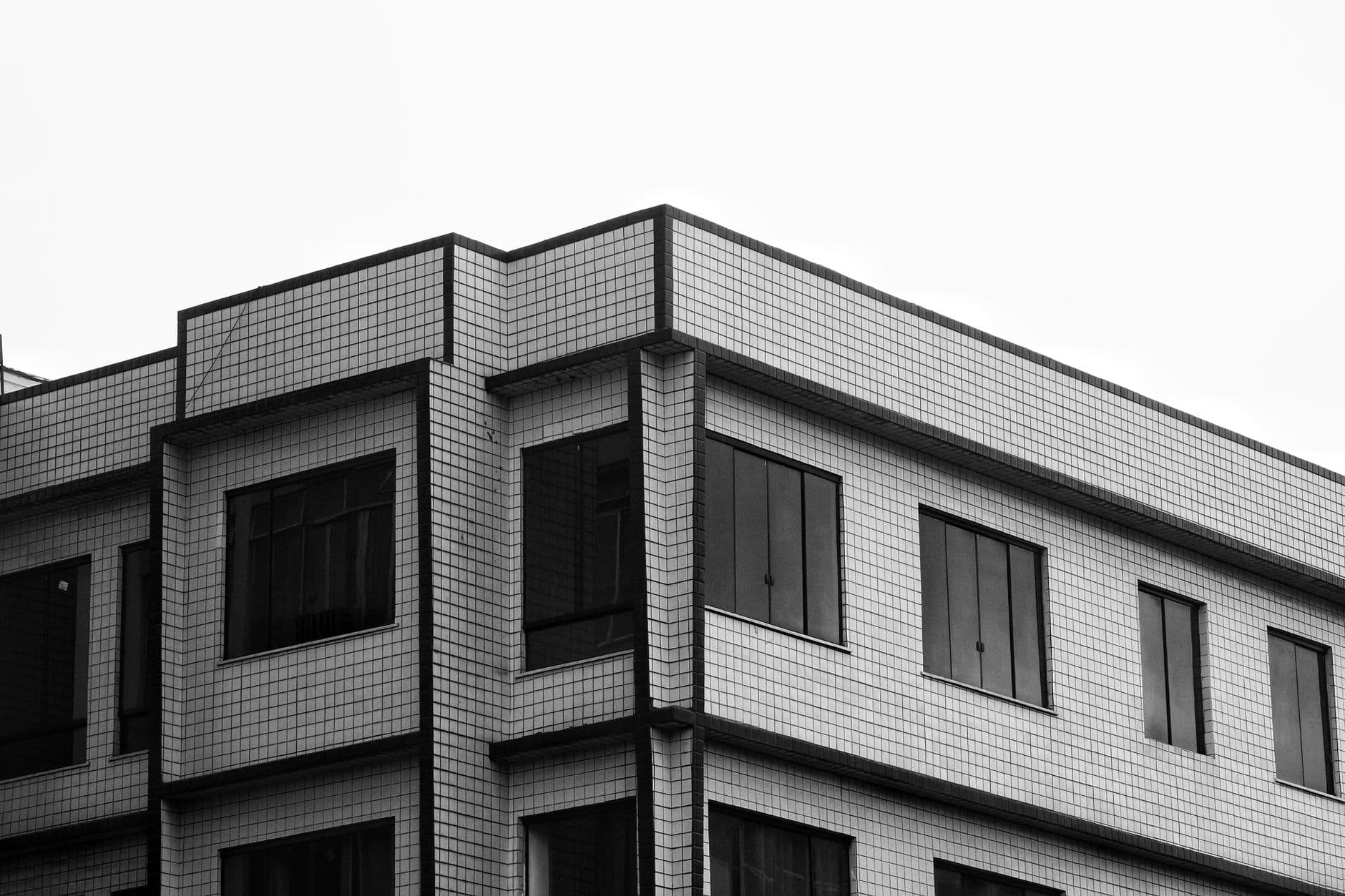 Black and white photo of modern building facade with geometric design.