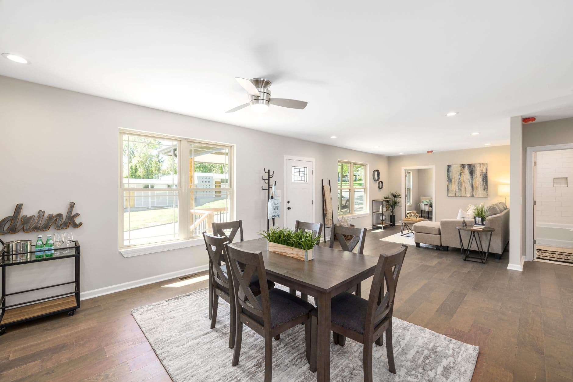 Spacious and modern open-plan living and dining area with natural light and stylish furnishings.