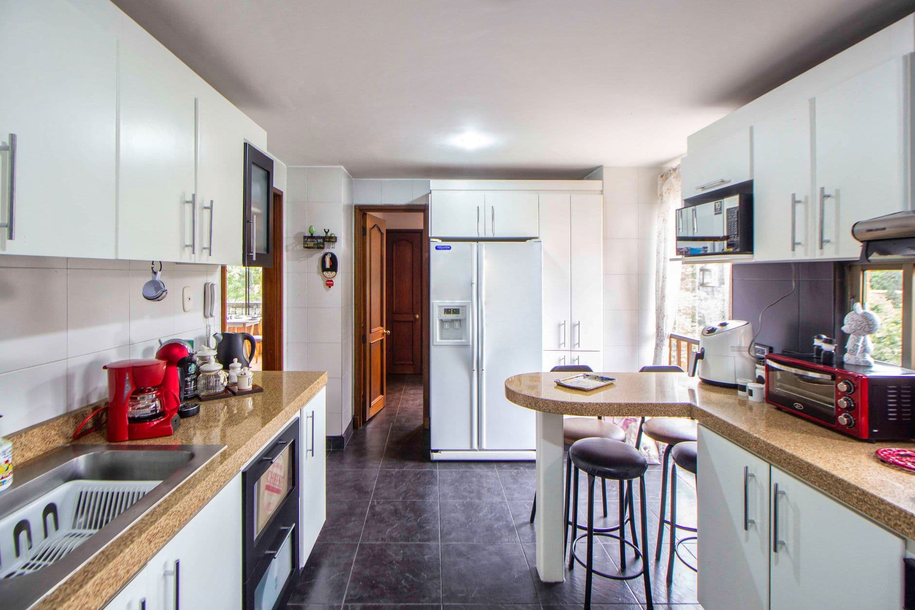 Bright and stylish kitchen featuring modern appliances and elegant cabinetry.