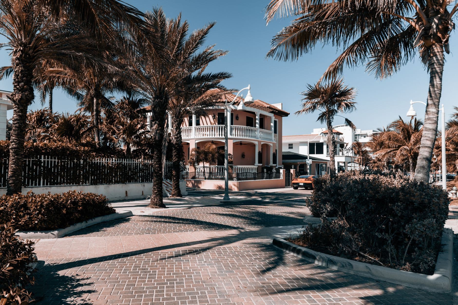 Charming tropical house surrounded by palm trees on a sunny street in Hollywood, Florida.