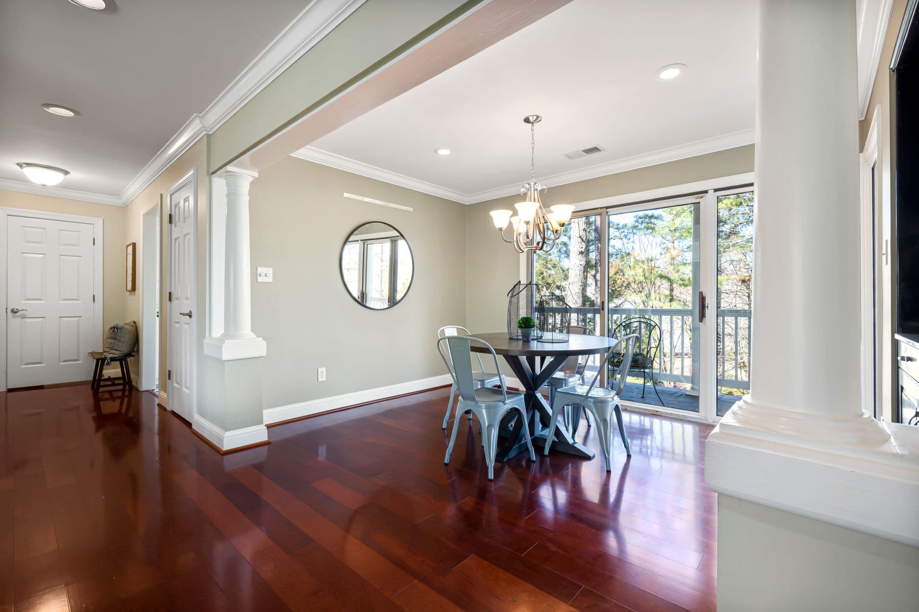 Elegant dining area featuring a round table and bright natural lighting.