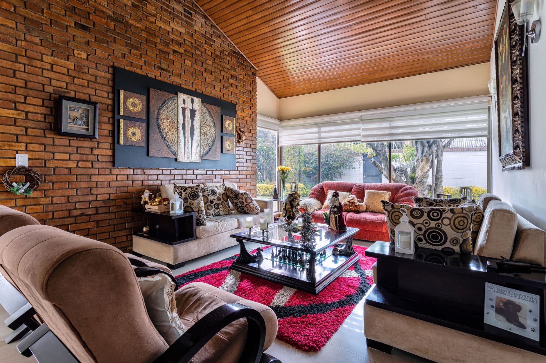 Inviting living room with brick wall, plush sofas, and artistic decoration in Bogotá, Colombia.