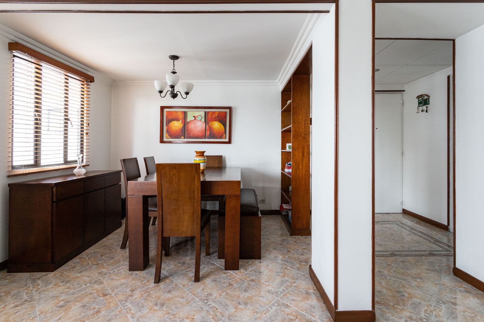 Modern dining room with elegant wooden furniture and artistic decor.