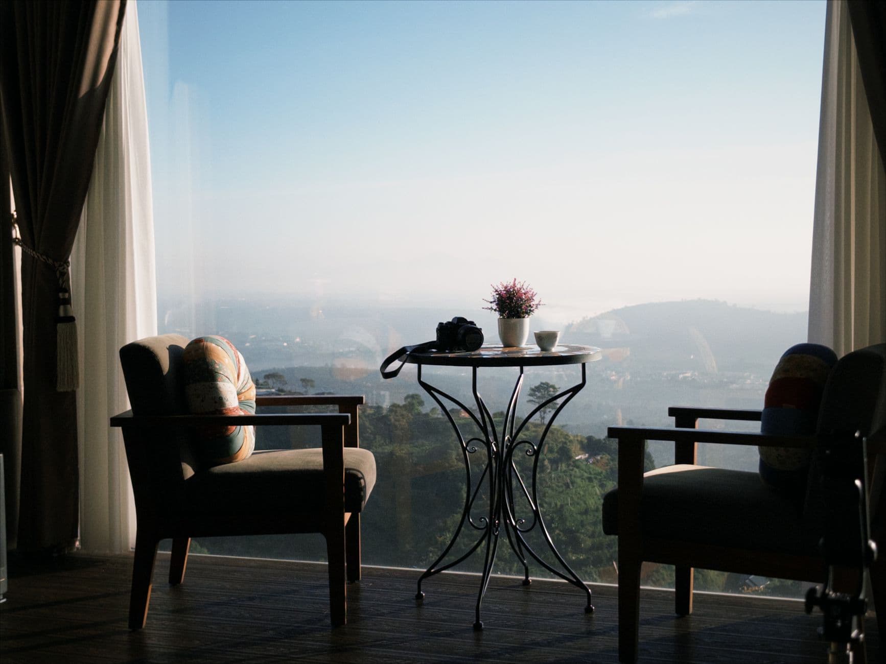 A peaceful indoor retreat with a scenic view through large windows, perfect for relaxation.