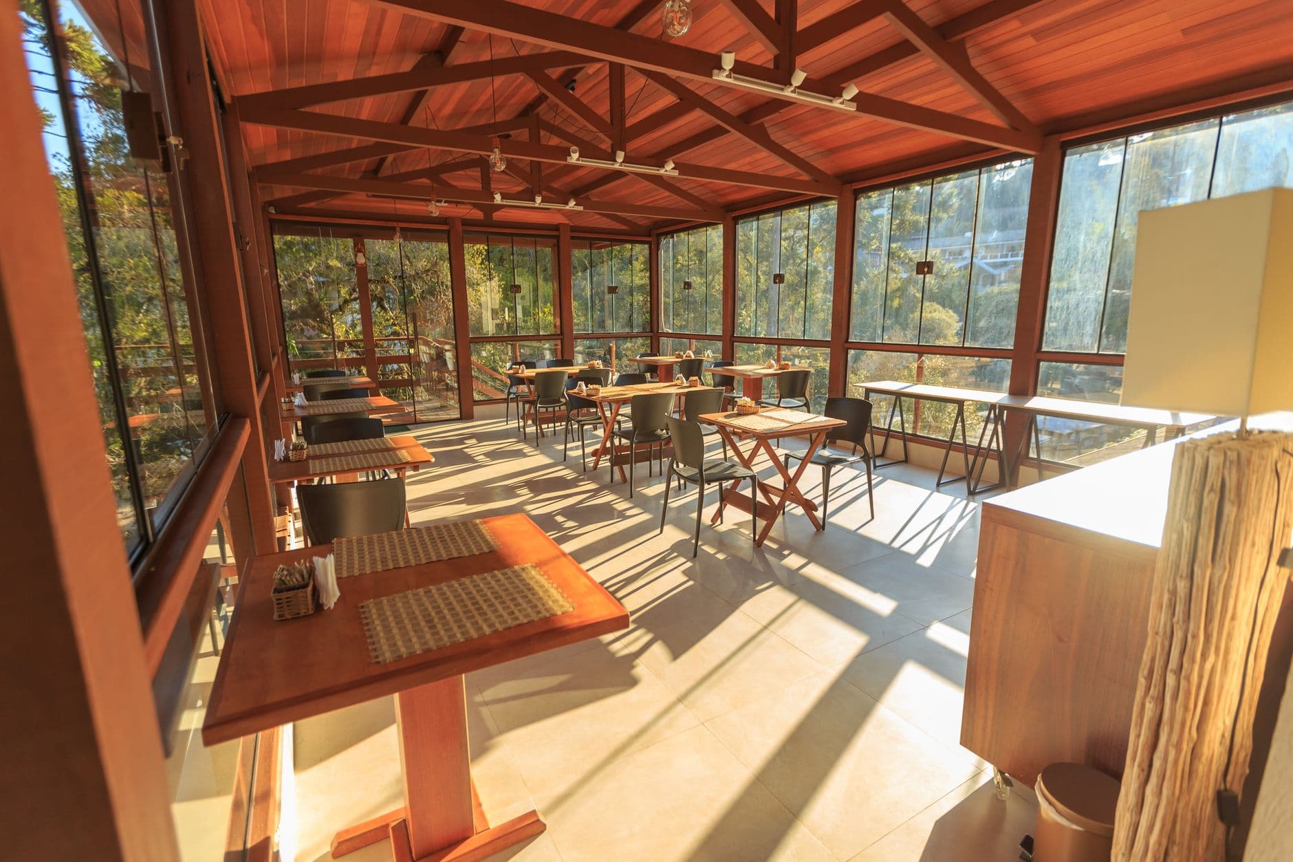 A cozy café with wooden decor and sunlit tables, offering a serene dining experience.