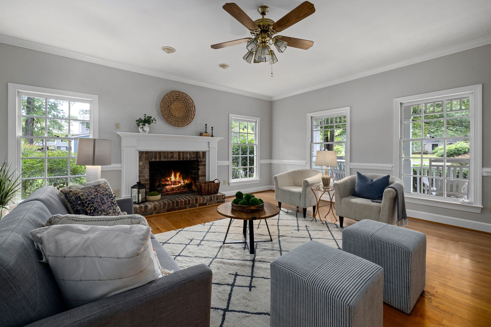 Bright living room with fireplace, modern furniture, and natural light.