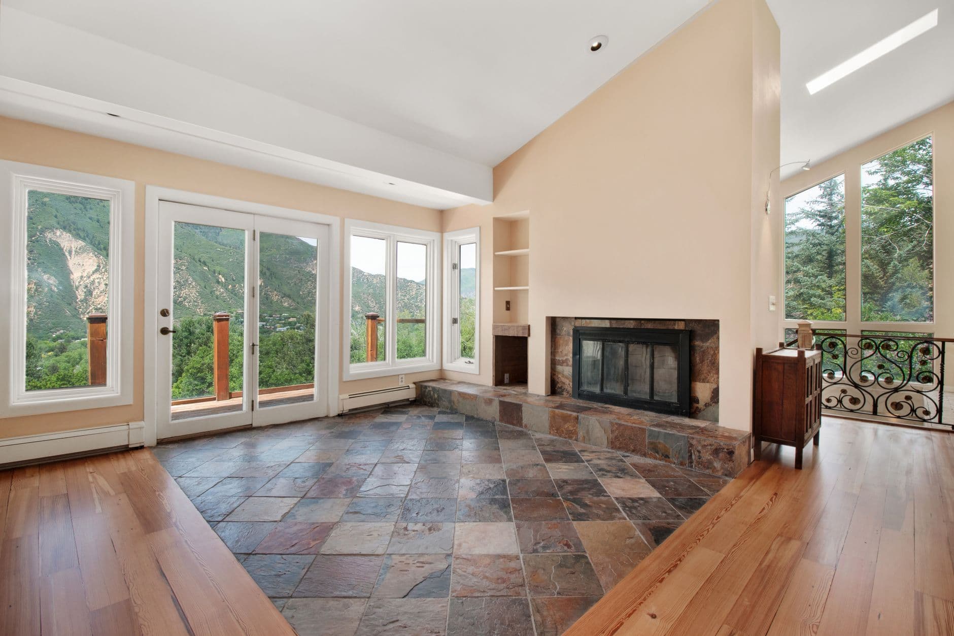 Bright, modern living room with a fireplace and scenic mountain views.