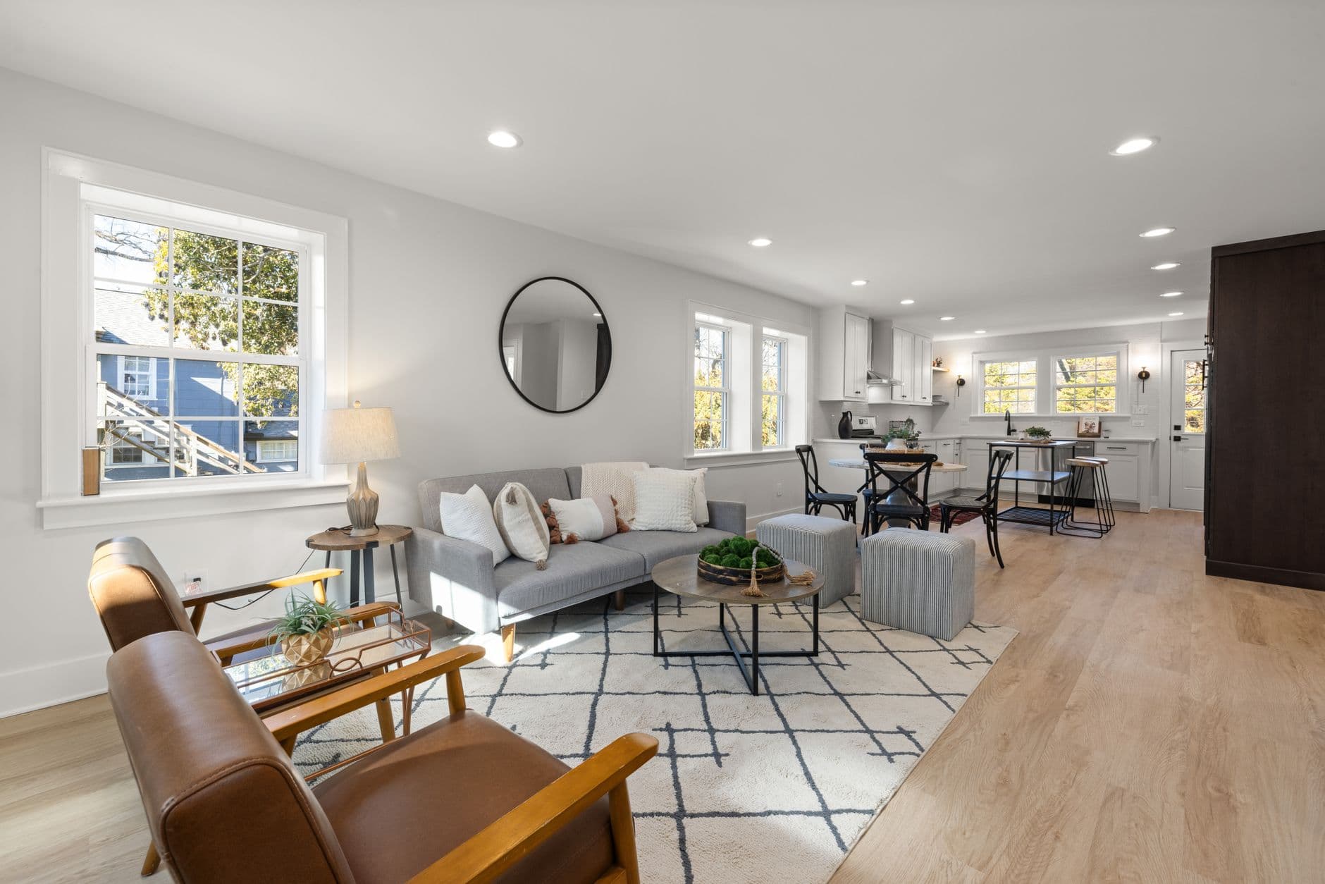Spacious living room with modern furniture and natural light, ideal for relaxation.